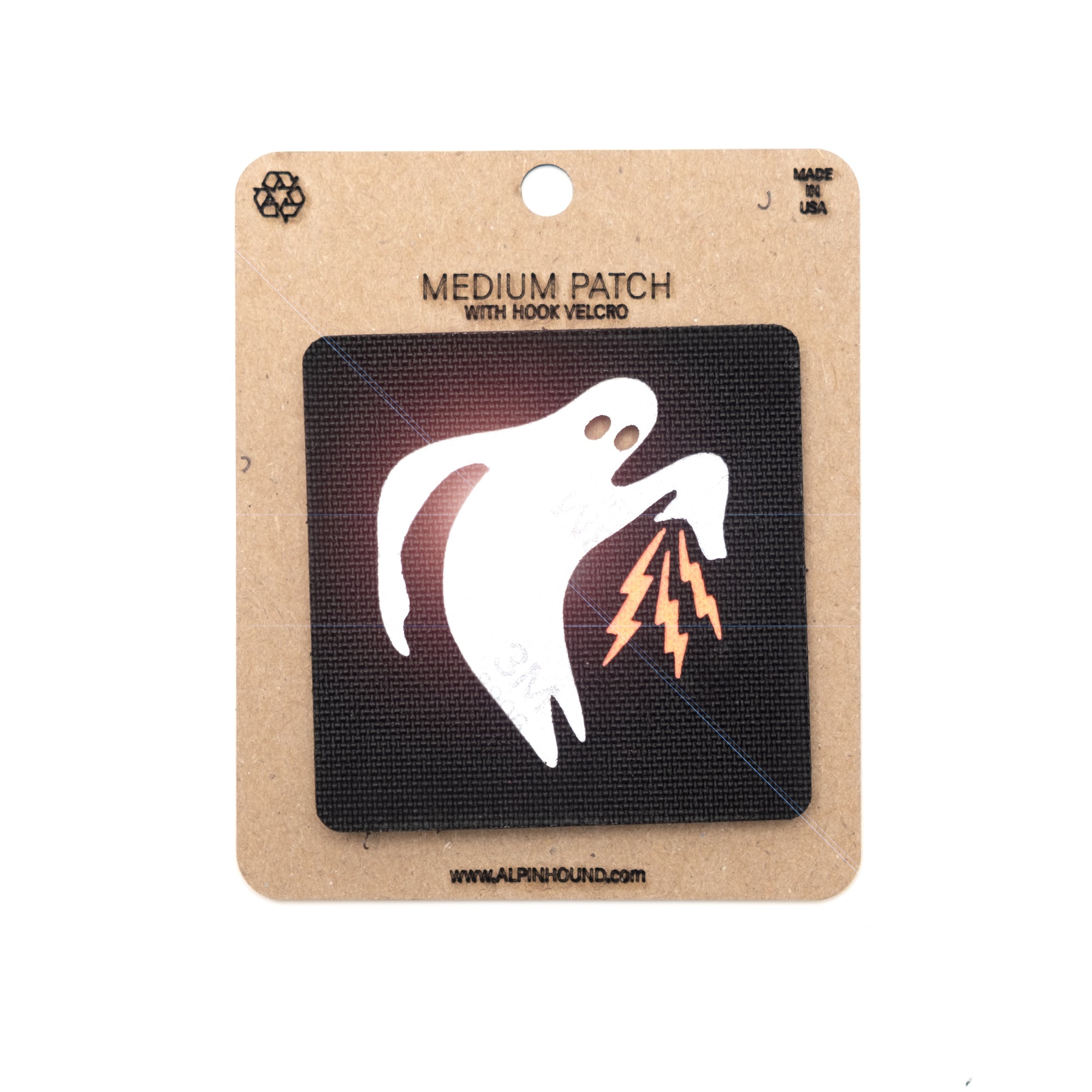 Ghost with lightning bolt patch on a cardboard backing with branding.