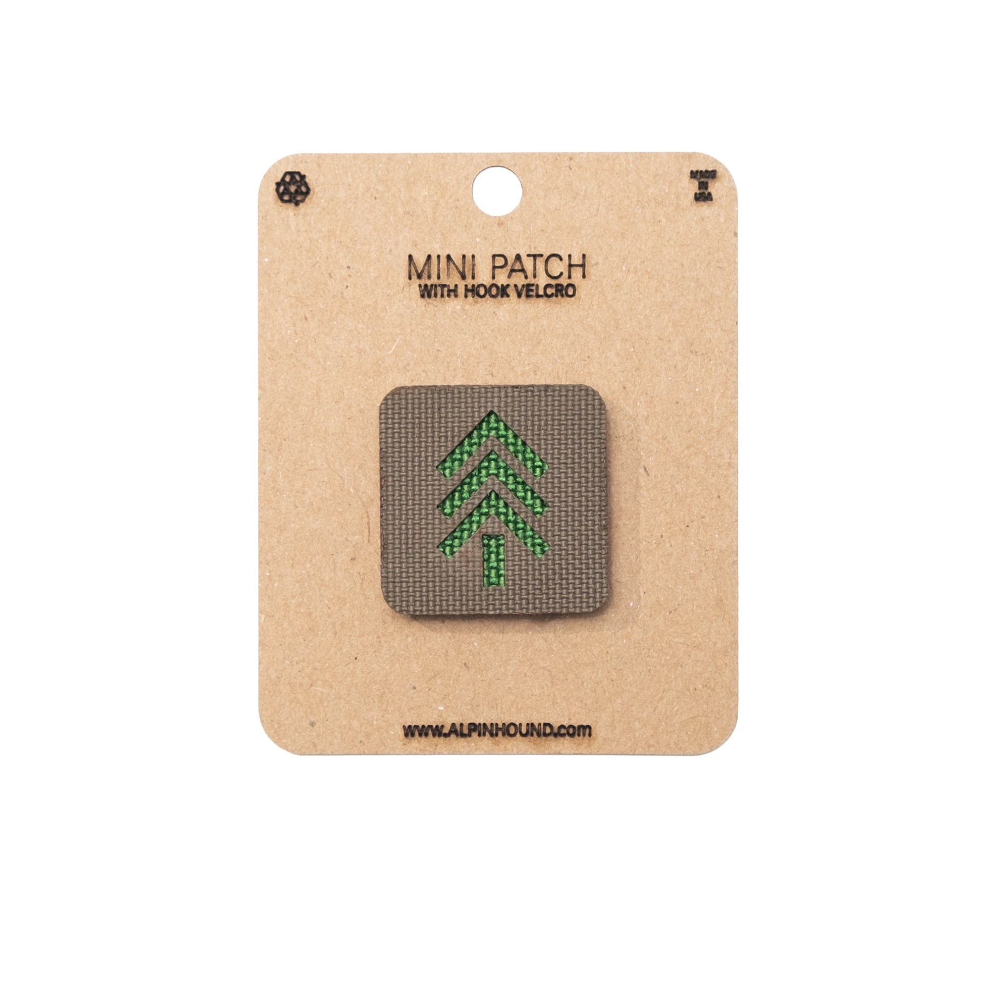 Mini patch with green tree design on a cardboard backing with brand name.