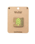 Mini patch with hook and velcro on a cardboard backing, featuring a green tree design.