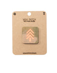 Mini patch with hook velcro on a cardboard backing, featuring a brand logo.