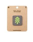 Mini patch with green arrow design on a cardboard backing with 'The Alpinhound' branding.