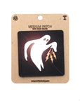 Ghost with lightning bolt patch on a cardboard backing with branding.