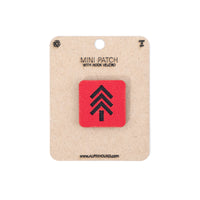 Red patch with black symbol on a cardboard backing with 'Alpinhound' branding.