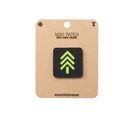 Mini patch with green tree design on a brown card with 'Alpinhound' branding.