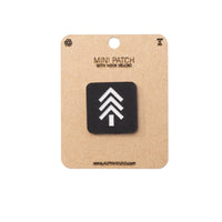Black patch with white symbol on a cardboard backing, featuring 'Alpinhound' branding.