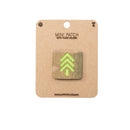 Mini patch with hook and velcro on a cardboard backing, featuring a green tree design.