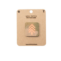 Mini patch with hook velcro on a cardboard backing, featuring a brand logo.